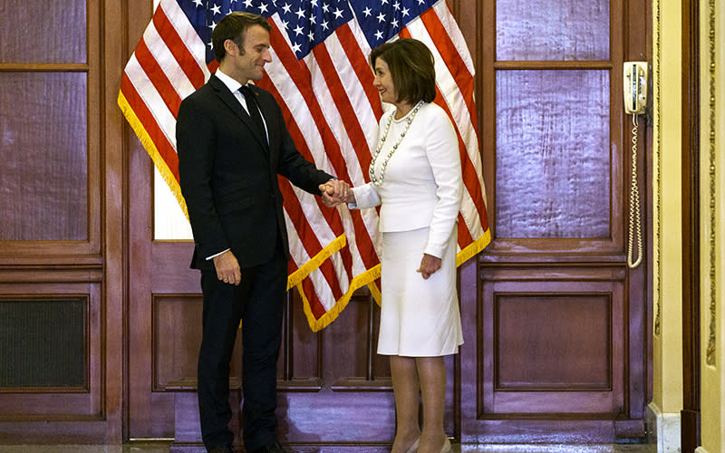 French President Emmanuel Macron and Speaker Nancy Pelosi (D-Calif.) shake hands