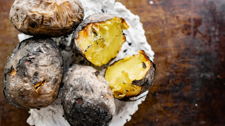 Ash-roasted potatoes on wooden board