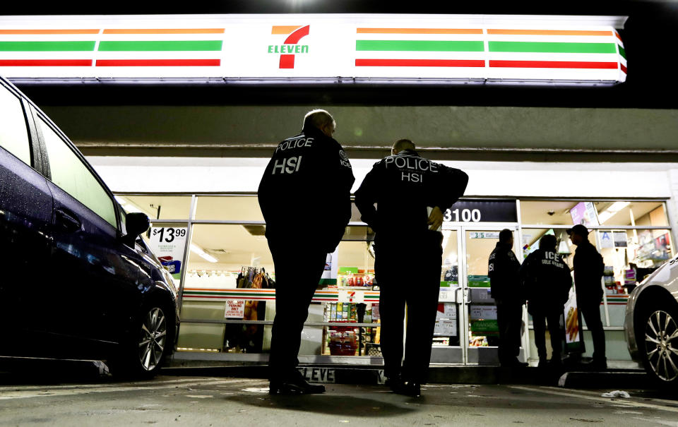 FILE - In this Jan. 10, 2018, file photo, U.S. Immigration and Customs Enforcement, ICE agents serve an employment audit notice at a 7-Eleven convenience store in Los Angeles. A federal appeals court has given the Trump administration a rare legal win in its efforts to crack down on sanctuary cities. In a 2-1 decision Friday, July 12, 2019, the 9th U.S. Circuit Court of Appeals said the Justice Department was within its rights to give priority status for multimillion-dollar community policing grants to departments that agree to cooperate with immigration officials. (AP Photo/Chris Carlson, File)