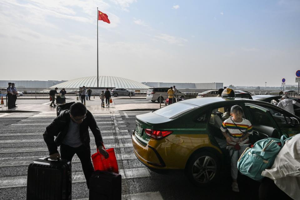 Travelers at Beijing Capital International Airport in Beijing, China, on Friday, Sept. 29, 2023.