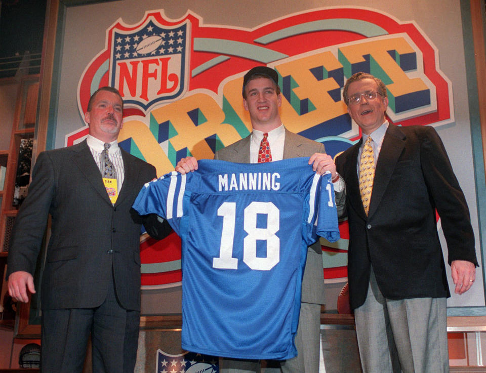 Peyton Manning is joined by Colts owner Jim Irsay, left, and NFL commissioner Paul Tagliabue after being picked first in the 1998 draft. (AP)