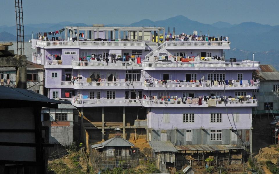 Ziona Chana's four-storeyed purple mansion is called 'Chhuanthar Run', which means 'The House of the New Generation', and is home to all 181 members of the family - Barcroft Media 