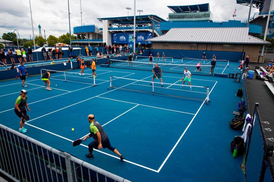 Amateur pickleball players participate in mixed double matches during the Professional Pickleball Association (PPA) Baird Wealth Management Open at the Lindner Family Tennis Center in Ohio. MUST CREDIT: Photo for The Washington Post by Arden S. Barnes.
