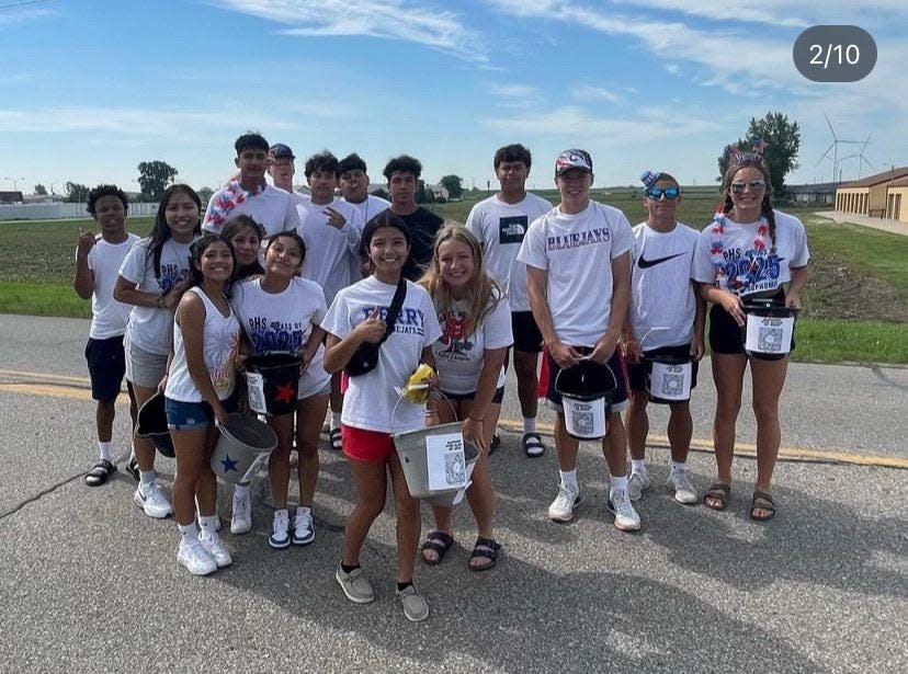 Members of the Perry High School Class of 2025 pose for a photo before walking in the Fourth of July parade to help raise funds for the 2024 prom.