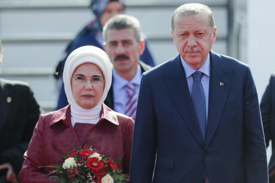 Turkey's President Recep Tayyip Erdogan, right, and his wife Emine, left, arrive at the airport Tegel for an official state visit in Germany at the capital Berlin, Thursday, Sept. 27, 2018. (AP Photo/Markus Schreiber)