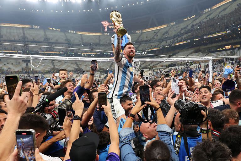 LUSAIL CITY, QATAR - DECEMBER 18: Lionel Messi of Argentina celebrates with the FIFA World Cup Trophy following his team's victory in during the FIFA World Cup Qatar 2022 Final match between Argentina and France at Lusail Stadium on December 18, 2022 in Lusail City, Qatar. (Photo by Marc Atkins/Getty Images)