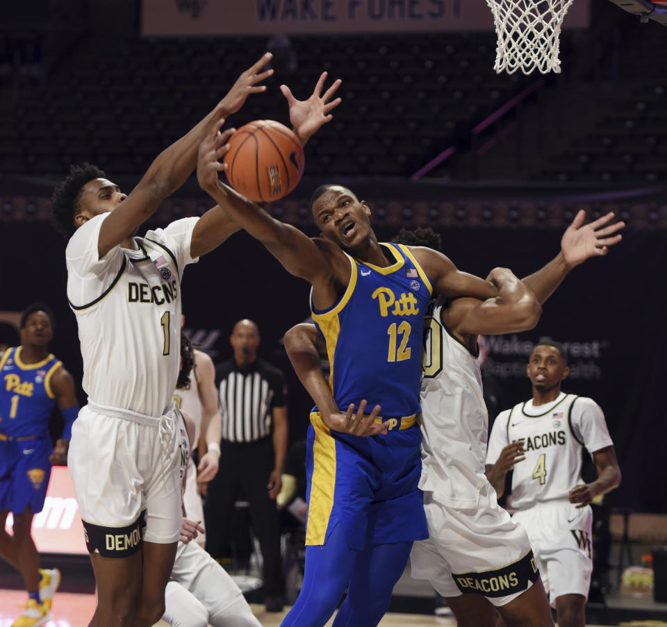 Pittsburgh's Abdoul Karim Coulibaly vies with Wake Forest's Isaiah Mucius (1) and Emmanuel Okpomo for a rebound during an NCAA college basketball game Saturday, Jan. 23, 2021, in Winston-Salem, N.C. (Walt Unks/The Winston-Salem Journal via AP)