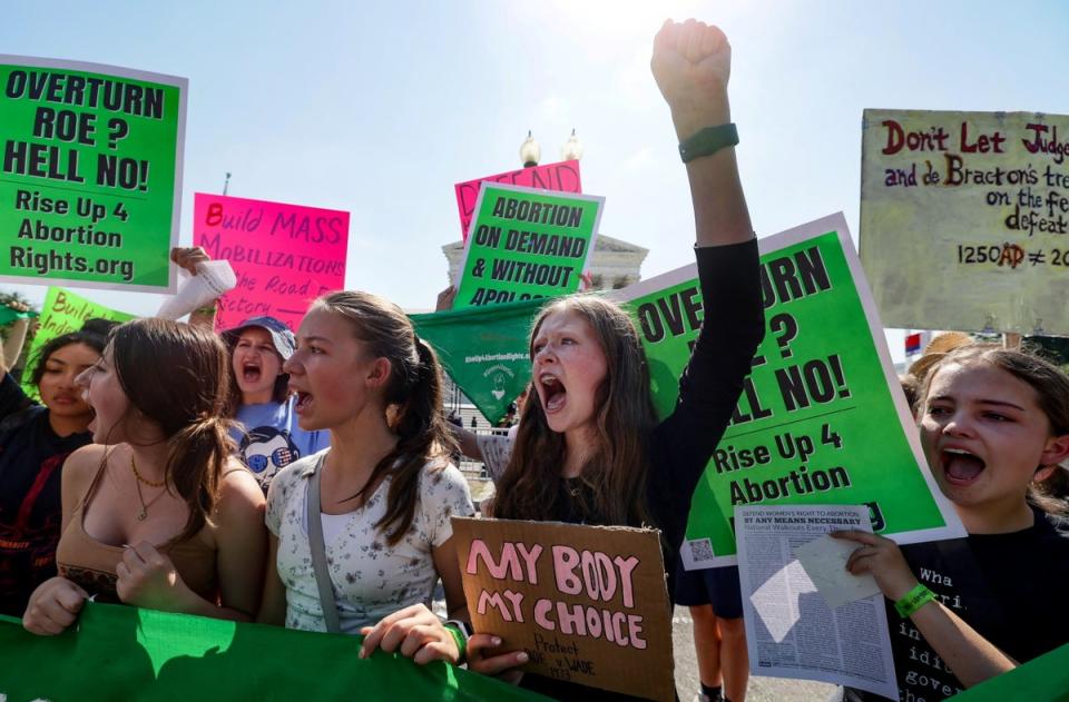 Abortion rights protesters demonstrate outside the Supreme Court on 13 June. (REUTERS)