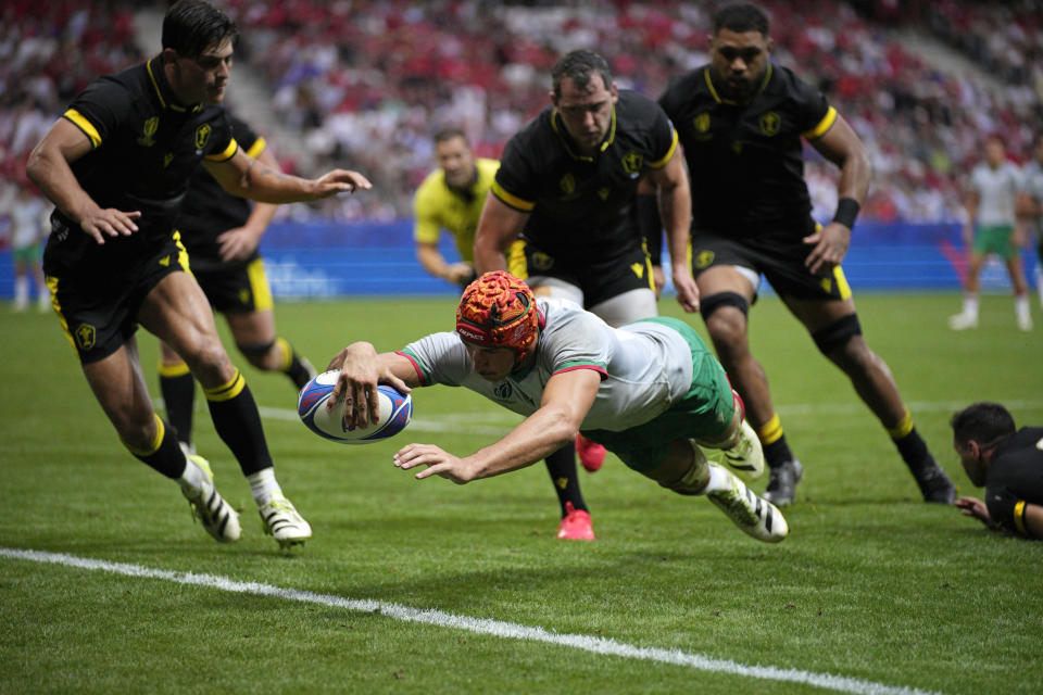 Portugal's Nicolas Martins scores a try during the Rugby World Cup Pool C match between Wales and Portugal at the Stade de Nice, Saturday, Sept. 16, 2023 in Nice, southern France. (AP Photo/Daniel Cole)