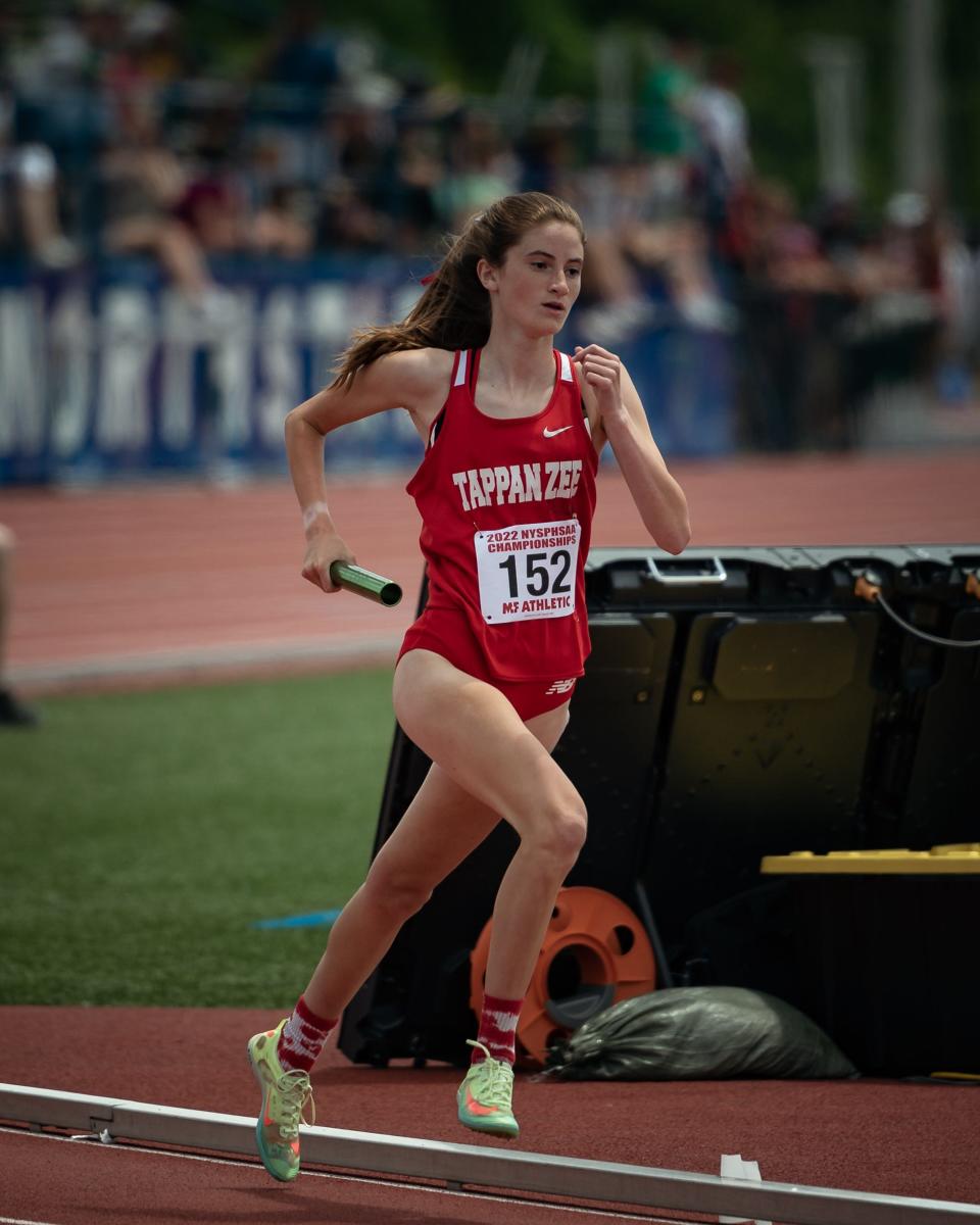 Tappan Zee's Cassidy Donovan carries the baton during the girls championships 4x800-meter relays at the  2022 NYSPHSAA Outdoor Track and Field Championships in Syracuse on Saturday, June 11, 2022. Tappan Zee medaled in the race.