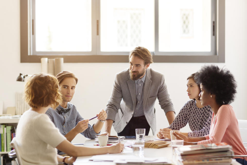 Young business colleagues in board room at office