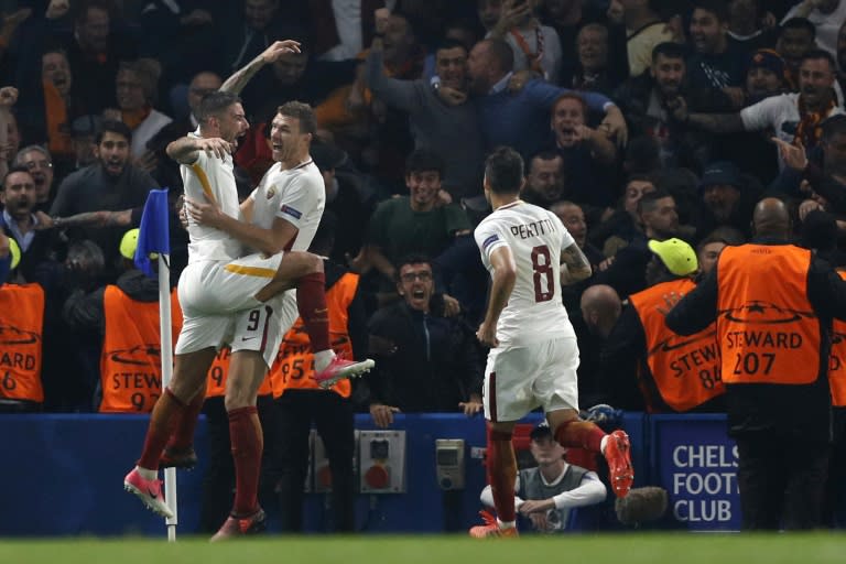 Roma's striker Edin Dzeko (C) celebrates after scoring his second goal against Chelsea with defender Aleksandar Kolarov at Stamford Bridge in London on October 18, 2017