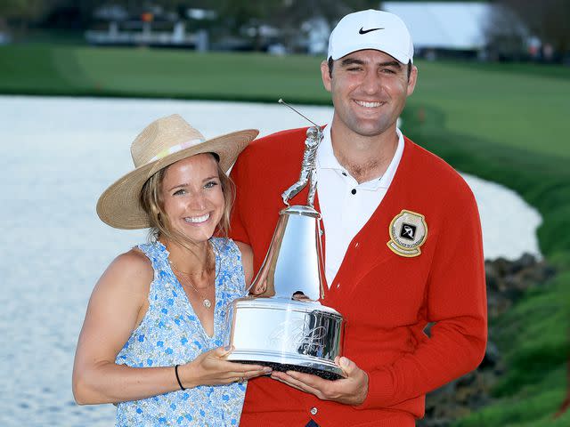 David Cannon/Getty Scottie Scheffler and his wife, Meredith, hold trophy after his one stroke win at the Arnold Palmer Invitational on March 6, 2022.