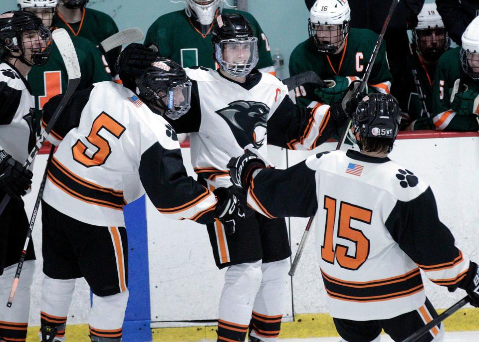 Marlborough’s Colin Glynn (center) celebrates with his teammates after scoring the first goal of the game in the third period during the Daily News Cup championships with Hopkinton at the New England Sports Center in Marlborough.