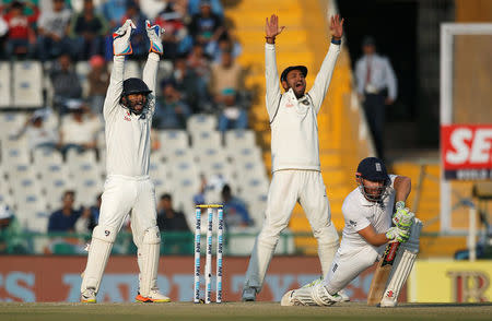 Cricket - India v England - Third Test cricket match - Punjab Cricket Association Stadium, Mohali, India - 26/11/16. India's Parthiv Patel (L) and Cheteshwar Pujara successfully appeal for the dismissal of England's Jonny Bairstow (R). REUTERS/Adnan Abidi