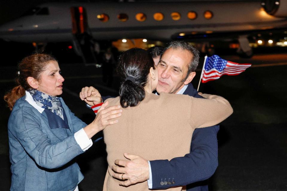PHOTO: Family members embrace freed American Emad Shargi after he and four fellow detainees were released in a prisoner swap deal between U.S and Iran, and arrived at Davison Army Airfield at Fort Belvoir, Va., Sept. 19, 2023. (Jonathan Ernst/Reuters)