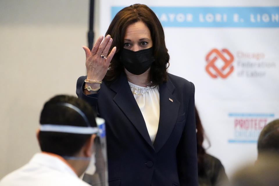 Vice President Kamala Harris looks at Osman Meah, a pharmacy manager at Jewel Osco who was giving the vaccinations, as she visits a COVID-19 vaccination site Tuesday, April 6, 2021, in Chicago. The site is a partnership between the City of Chicago and the Chicago Federation of Labor. (AP Photo/Jacquelyn Martin)