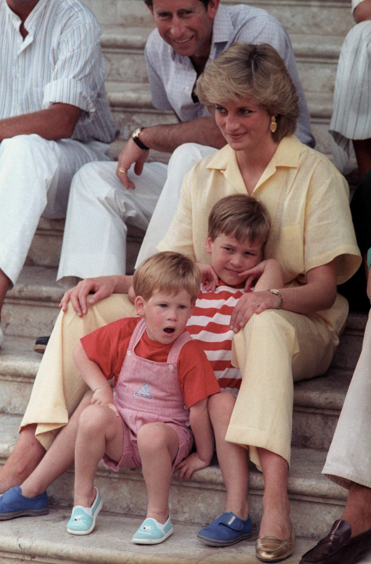 Princess Diana with her two sons Prince William, 6, and Prince Harry, 3, (front) as they pose during the morning's picture session on August 9, 1987 in Palma de Mallorca, Spain.  REUTERS/Hugh Peralta