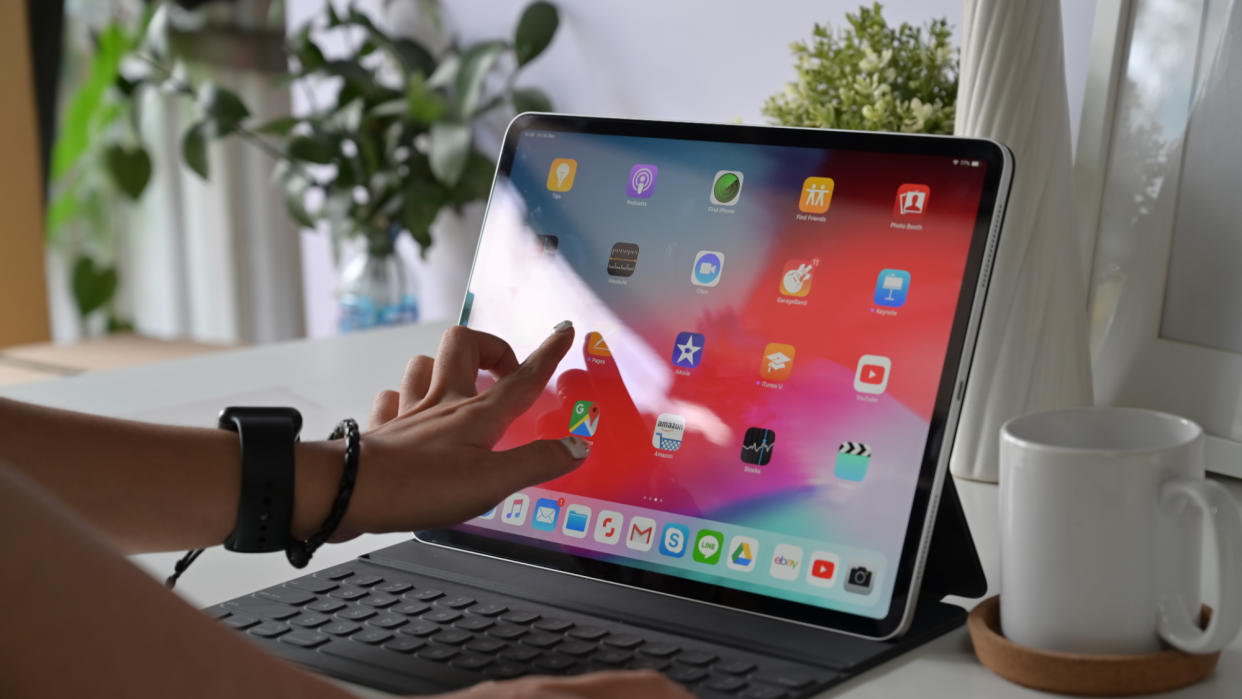   Woman using Apple iPad pro 2018 on home business desk table. 