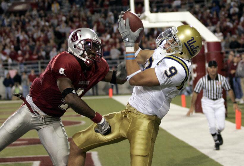 UCLA wide receiver Marcus Everett (9) catches a pass for a touchdown as Washington State.