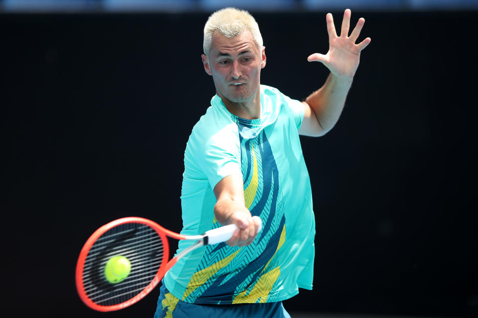 MELBOURNE, AUSTRALIA - JANUARY 11:  Bernard Tomic of Australia plays a forehand in his match against Roman Safiullin of Russia during day two of 2022 Australian Open Qualifying at Melbourne Park on January 11, 2022 in Melbourne, Australia. (Photo by Graham Denholm/Getty Images)
