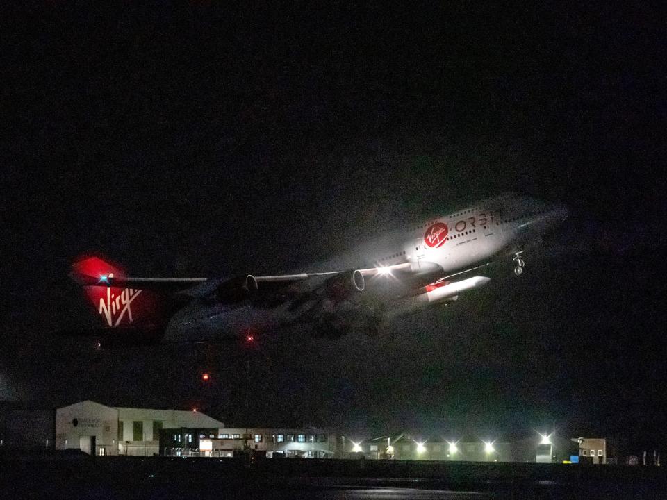 A repurposed Virgin Atlantic Boeing 747 aircraft, named Cosmic Girl, carrying Virgin Orbit's LauncherOne rocket, takes off from Spaceport Cornwall at Cornwall Airport, Newquay.