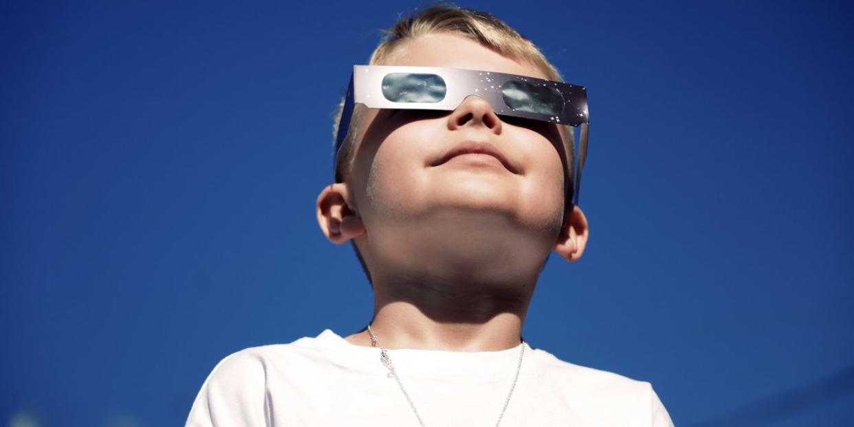 boy looking at solar eclipse - solar eclipse activities for kids