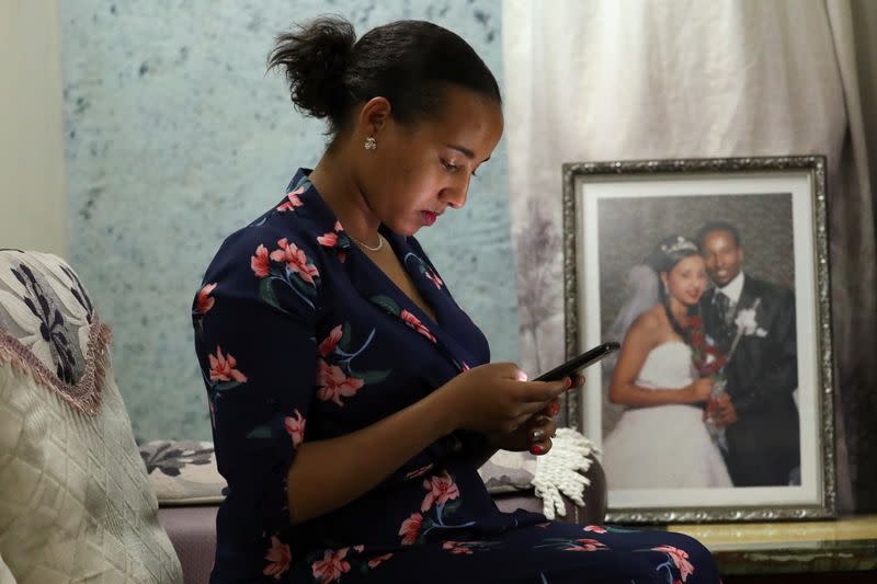 Hawi Desalegn, wife of Reuters cameraman Kumerra Gemechu, uses a cellphone at her house in Addis Ababa