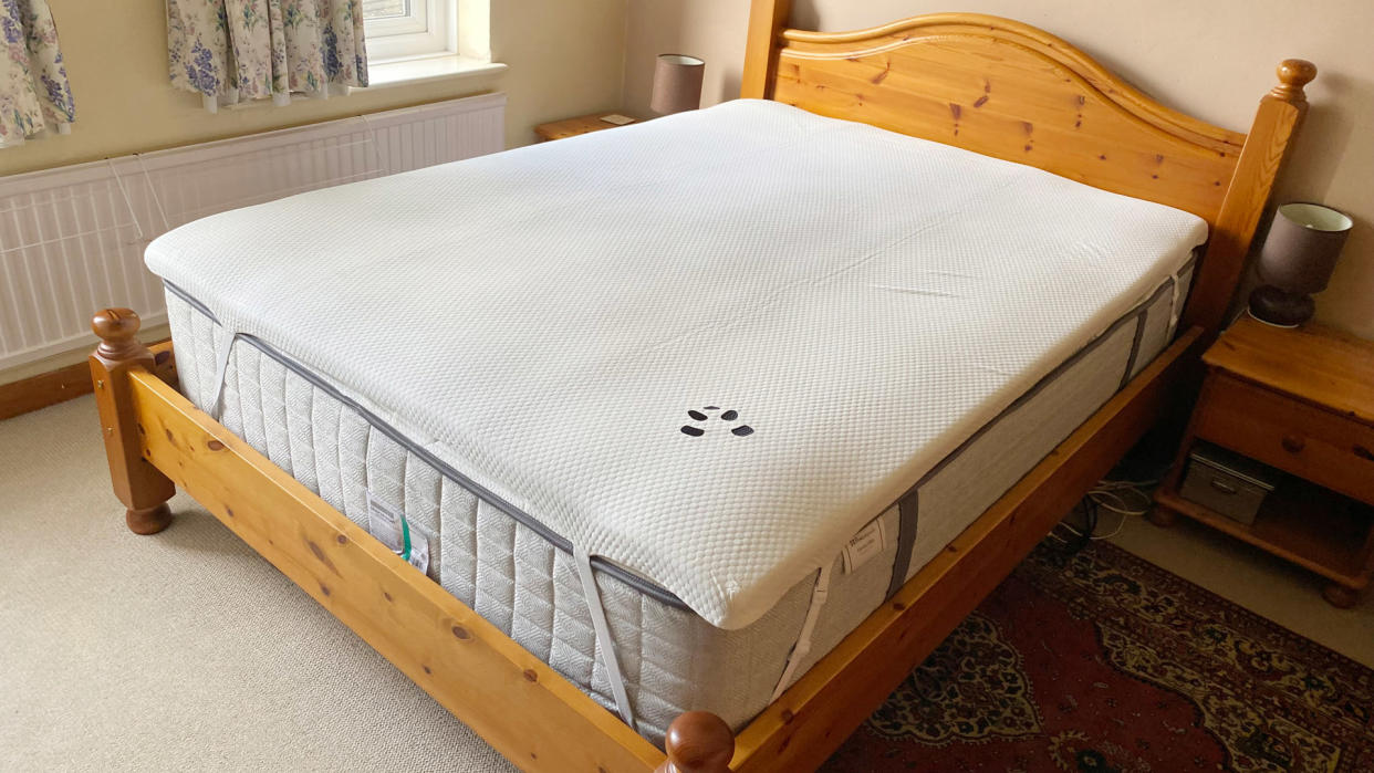  The Panda Bamboo Mattress Topper on a bed in a bedroom. 