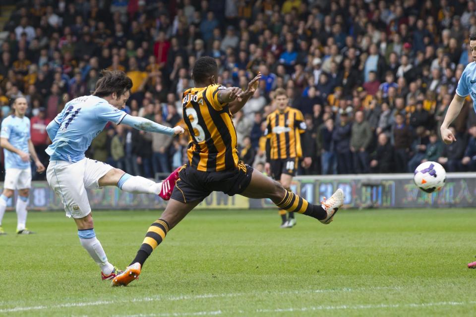 Manchester City's David Silva, left, scores against Hull City during their English Premier League soccer match at the KC Stadium, Hull, England, Saturday March 15, 2014. (AP Photo/Jon Super)