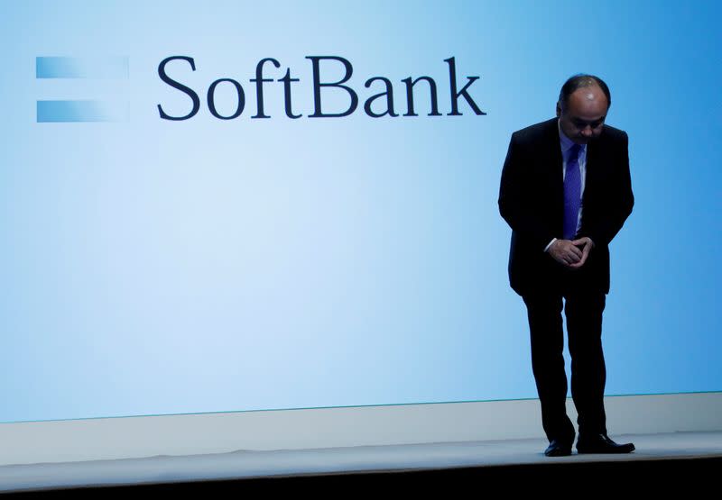 FILE PHOTO: FILE PHOTO: Japan's SoftBank Group Corp Chief Executive Masayoshi Son bows his head after his presentation at a news conference in Tokyo