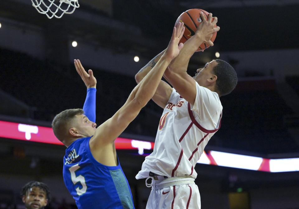 Florida Gulf Coast Eagles guard Chase Johnston (5) defends a shot by USC Trojans forward Kobe Johnson (0) in the first half at Galen Center.