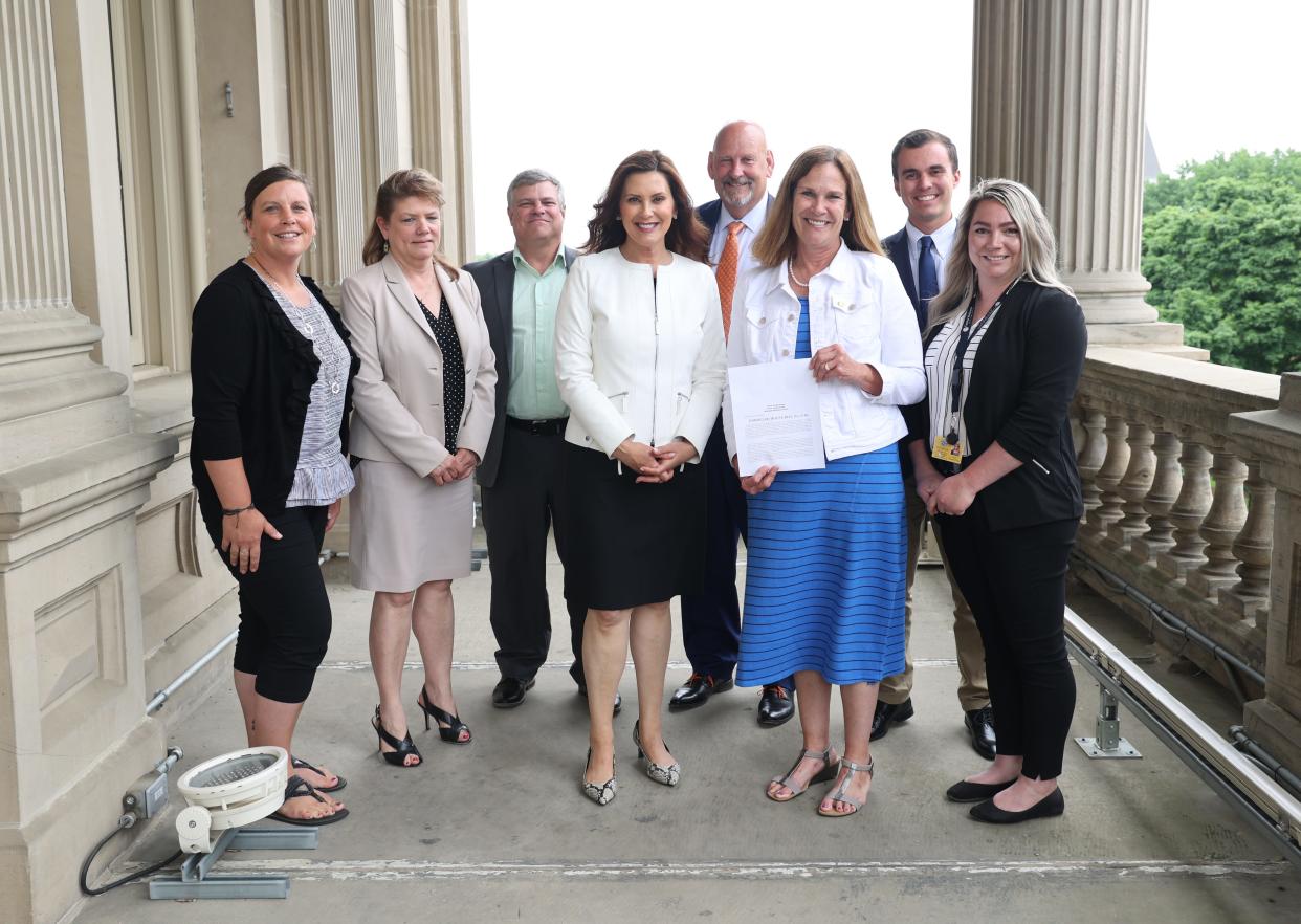 From left, Cassie Lietaert, human resources manager for Centra Wellness Network; Kathryn Szewczuk, executive director of the Lenawee Community Mental Health Authority; Joseph “Chip” Johnson, executive director of Centra Wellness Network; Gov. Gretchen Whitmer; state Sen. Curt VanderWall; state Rep. Mary Whiteford; Lee Belding, legislative director for Whiteford; and Hannah Tomaszewski, clinician for Catholic Human Services Inc., attend the signing ceremony June 14 at the Capitol in Lansing for a bill that increases access to mental health services.