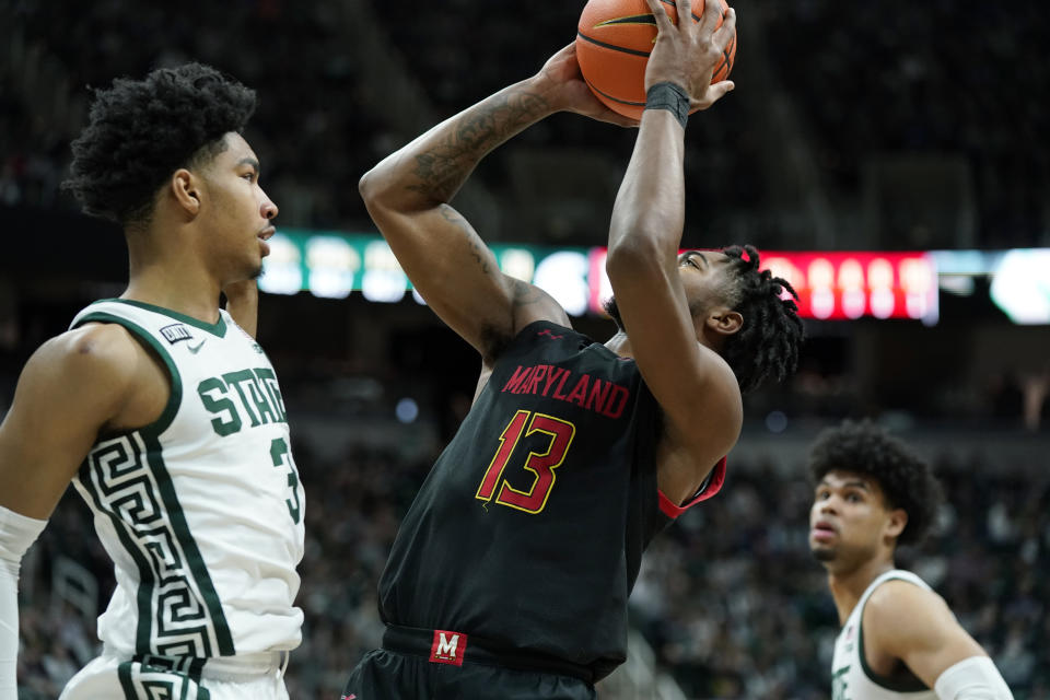 Maryland guard Hakim Hart (13) is fouled by Michigan State guard Jaden Akins (3) during the first half of an NCAA college basketball game, Sunday, March 6, 2022, in East Lansing, Mich. (AP Photo/Carlos Osorio)