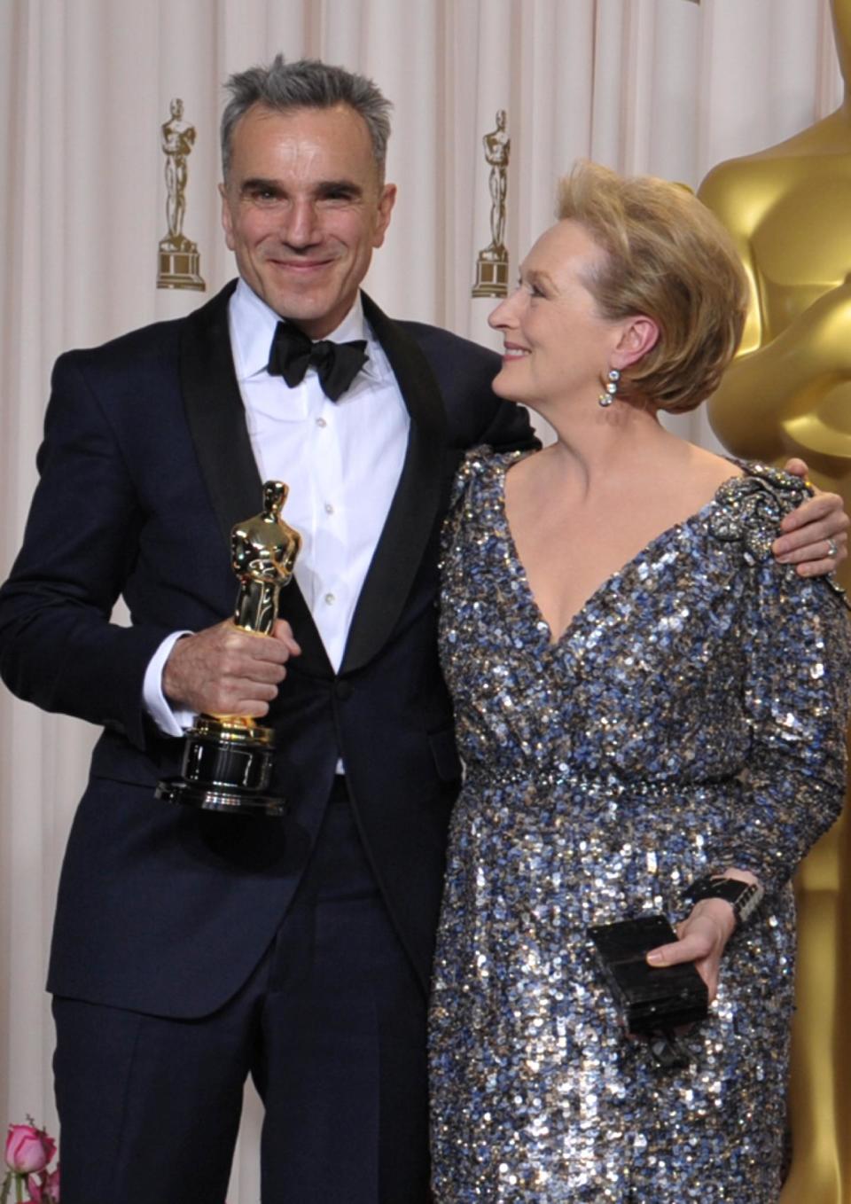 Daniel Day-Lewis, with his award for best actor in a leading role for "Lincoln," left, and presenter Meryl Streep pose during the Oscars at the Dolby Theatre on Sunday Feb. 24, 2013, in Los Angeles. (Photo by John Shearer/Invision/AP)