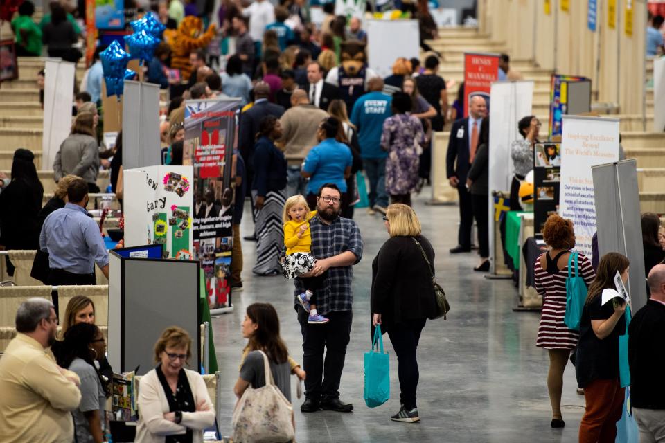 Parents and students visit schools' booths during the School Choice Festival at the Fairgrounds in Nashville on Oct. 15, 2019.