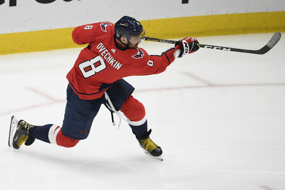 FILE - Washington Capitals left wing Alex Ovechkin (8) follows through on a shot during the second period in Game 5 of an NHL hockey Stanley Cup first-round playoff series against the Boston Bruins in Washington, in this Sunday, May 23, 2021, file photo. Ovechkin re-signed with the Washington Capitals on the eve of free agency, Tuesday, July 27, 2021, inking a four-year deal worth $40 million.(AP Photo/Nick Wass, File)