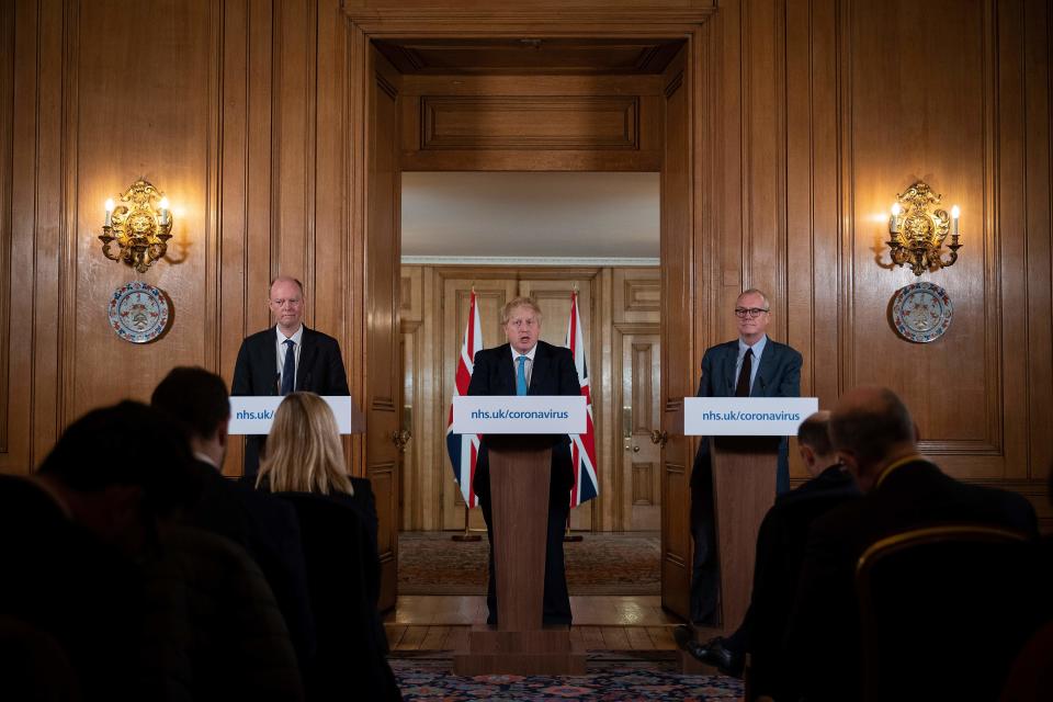 Chief Medical Officer Chris Whitty (L) and Chief Scientific Adviser Patrick Vallance (R) look on as Britain's Prime Minister Boris Johnson addresses a news conference to give a daily update on the government's response to the novel coronavirus COVID-19 outbreak, inside 10 Downing Street in London on March 19, 2020. (Photo by Leon Neal / POOL / Getty Images) (Photo by LEON NEAL/POOL/AFP via Getty Images)