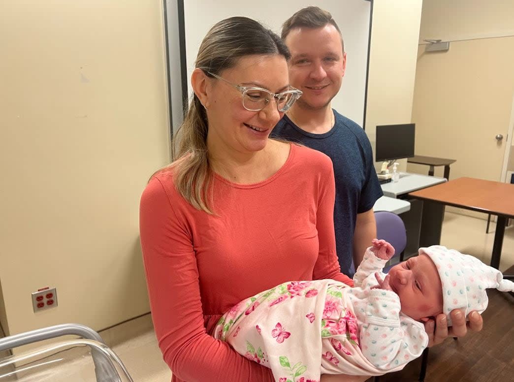 Parents Julia Goryn and Travis Stutsky show off their daughter Taylor Stutsky, who is B.C.'s first baby of 2024. (Baneet Braich/CBC - image credit)