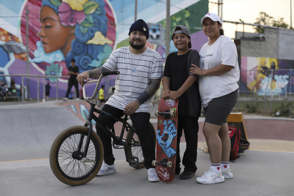 Husband and wife Alonso and Jessica Martinez pose for a photo with their son Jared, who live in the Soyapango municipality, at a sports complex for freestyle BMX bicycle in the Mejicanos municipality of the San Salvador department, El Salvador, Sunday, March 19, 2023. One year ago, President Nayib Bukele suspended constitutional rights and started an all-out offensive on gangs, triggering a radical transformation in some of the country’s most dangerous areas where many Salvadorans enjoy new freedoms like being outside at night, delivery services and open businesses without gangs extorting them for money. (AP Photo/Salvador Melendez)