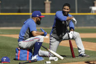 Texas Rangers' Rougned Odor, left, and Elvis Andrus talk while waiting to bat during spring training baseball practice Monday, Feb. 17, 2020, in Surprise, Ariz. (AP Photo/Charlie Riedel)