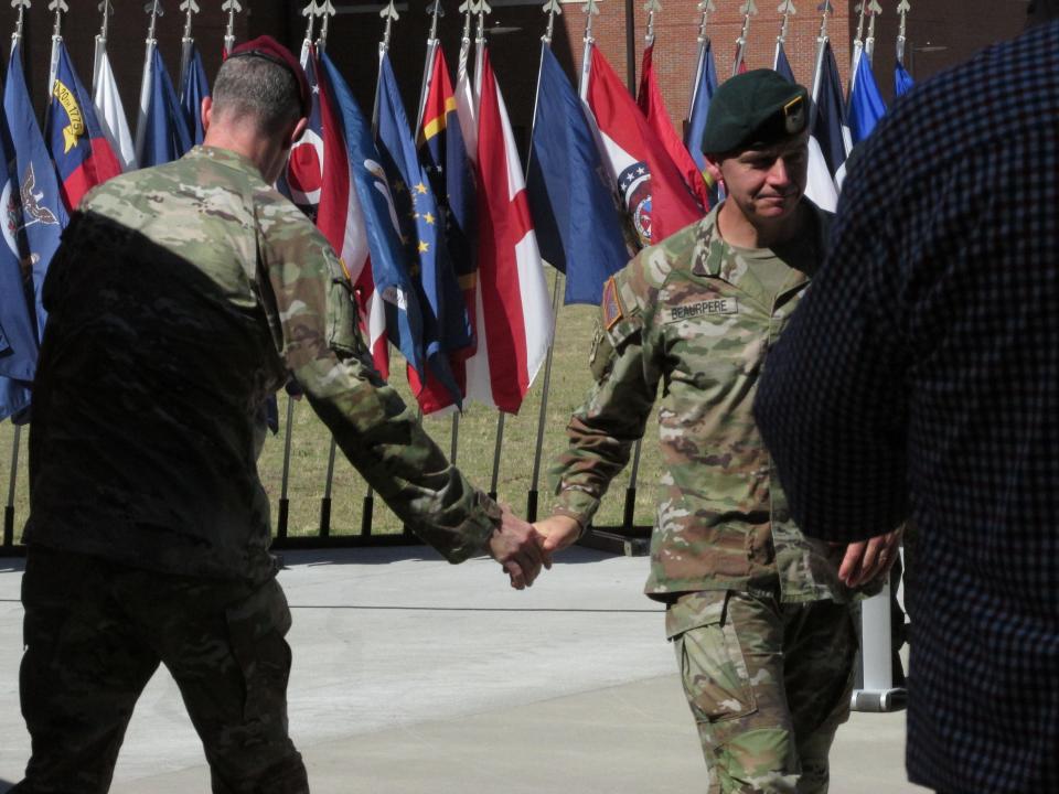 Brig. Gen. Guillaume "Will" Beaurpere, right, outgoing commander for the John F. Kennedy Special Warfare Center and School, shakes hands with Brig. Gen. Jason Slider, incoming commander, during a command change ceremony Friday, June 21, 2024, at Fort Liberty.