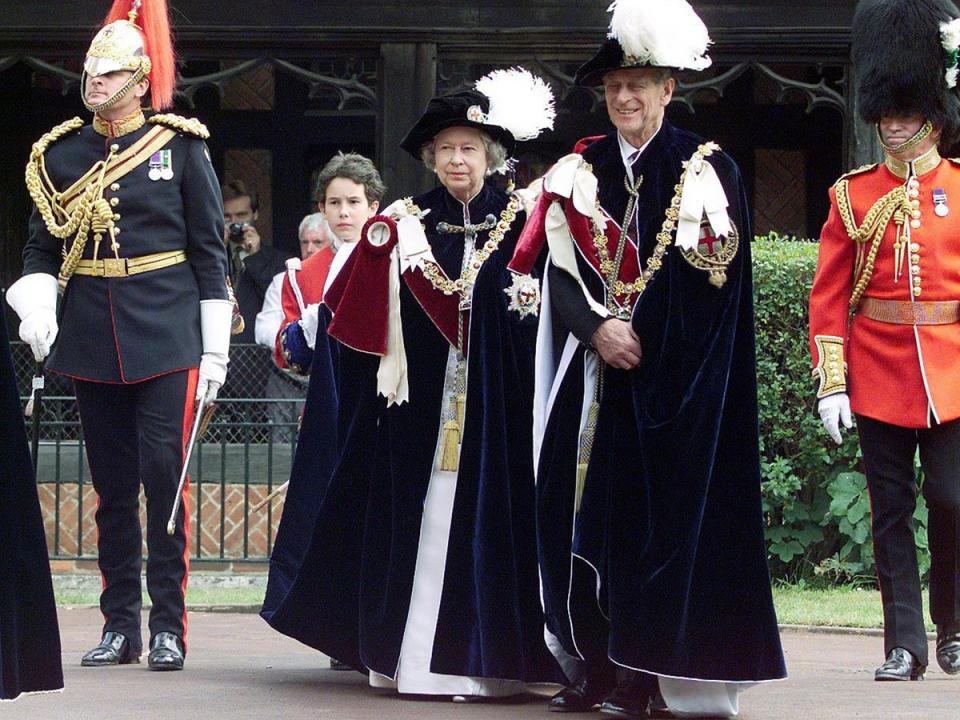 Queen Elizabeth II, accompanied by the Duke of Edinburgh, make their way into St. George's Chapel at Windsor for the annual Garter ceremony, 1999 (AFP/Getty)