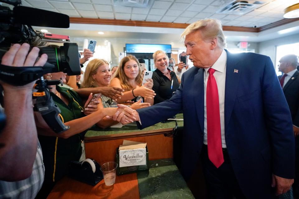 Former President Donald Trump greets supporters at Versailles restaurant on Tuesday, June 13, 2023, in Miami.