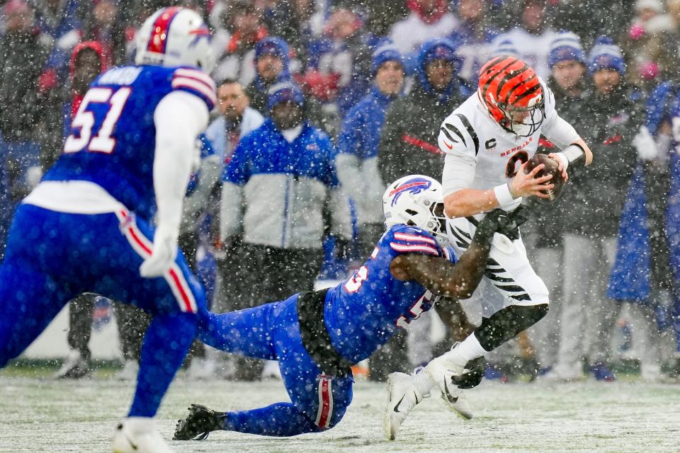 Cincinnati Bengals quarterback Joe Burrow (9) is tackled by Buffalo Bills defensive end Boogie Basham (55) during the first quarter of an NFL division round football game, Sunday, Jan. 22, 2023, in Orchard Park, N.Y. (AP Photo/Seth Wenig)