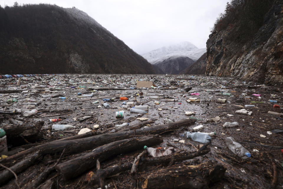 Waste floating in the Drina river near Visegrad, Bosnia, Friday, Jan. 20, 2023. Tons of waste dumped in poorly regulated riverside landfills or directly into the rivers across three Western Balkan countries end up accumulating during high water season in winter and spring, behind a trash barrier in the Drina River in eastern Bosnia. (AP Photo/Armin Durgut)