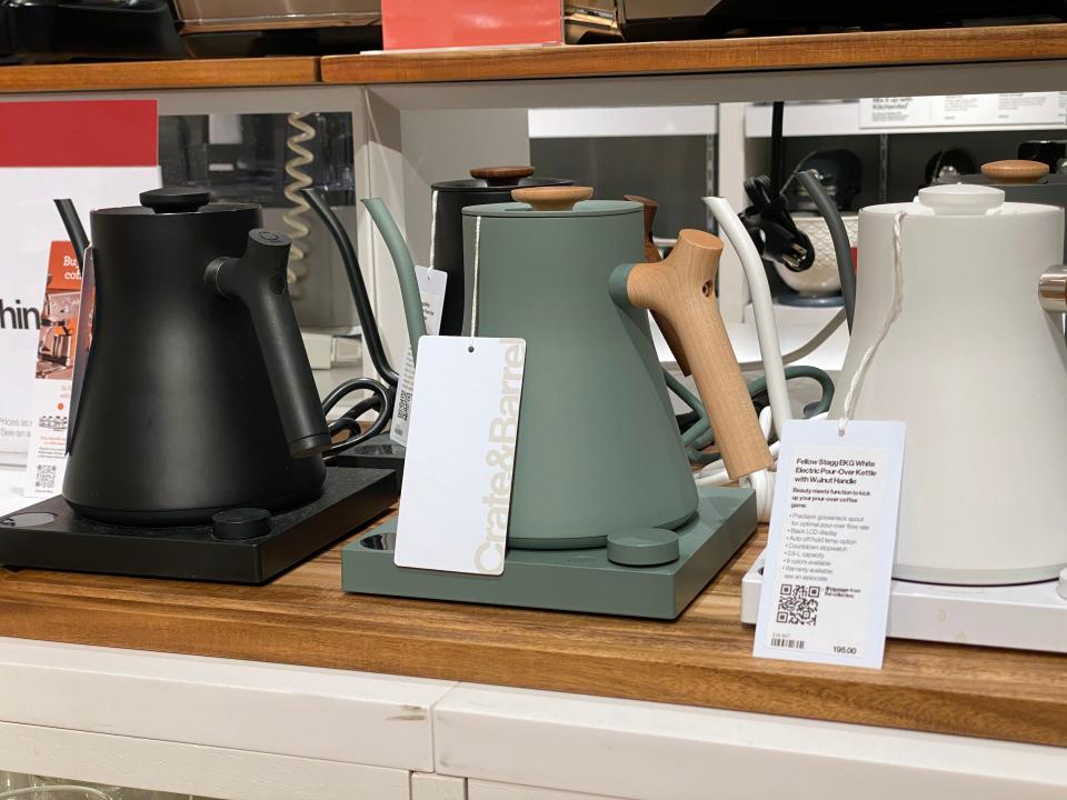 Modern-looing tea kettles in black, green, and white colors at Crate and Barrel