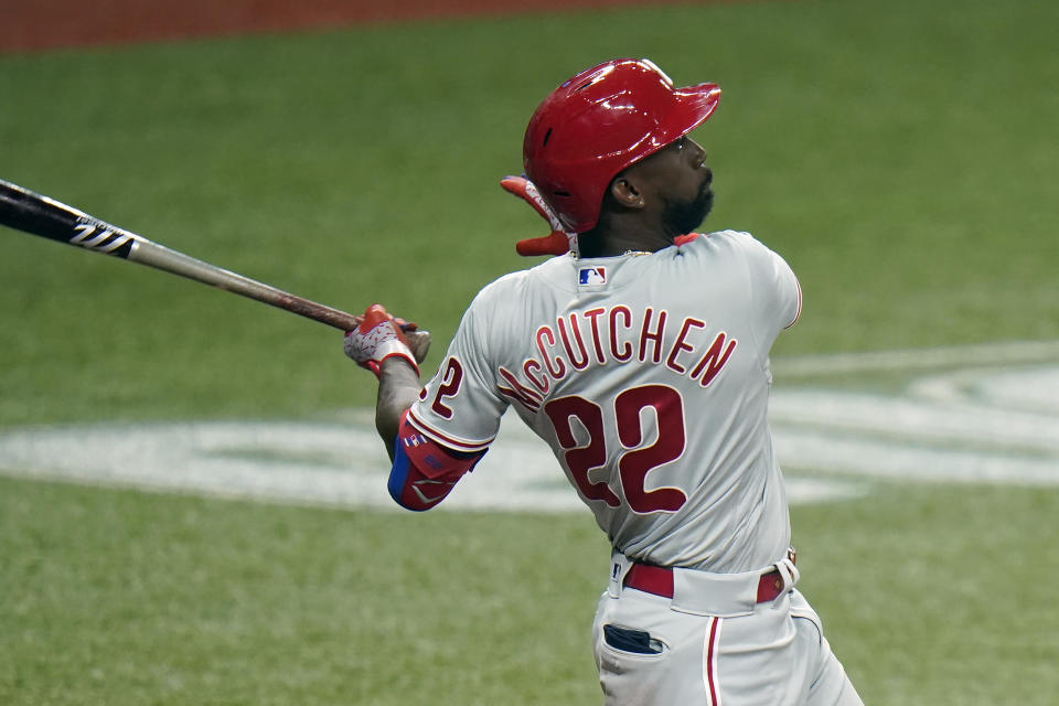 Philadelphia Phillies' Andrew McCutchen (22) follows the flight of his solo home run off Tampa Bay Rays relief pitcher Peter Fairbanks during the fifth inning of a baseball game Saturday, Sept. 26, 2020, in St. Petersburg, Fla. (AP Photo/Chris O'Meara)