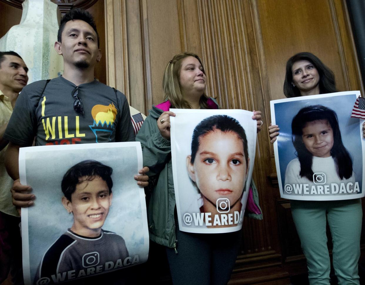 <span class="caption">Three DACA recipients hold pictures of themselves as children newly arrived in the United States at a congressional meeting, Sept. 6, 2017.</span> <span class="attribution"><a class="link " href="https://newsroom.ap.org/detail/CongressImmigration/410c1865769b4e8e8e68869c9a68fbbb/photo?Query=daca%20AND%20dreamer&mediaType=photo&sortBy=arrivaldatetime:desc&dateRange=Anytime&totalCount=87&currentItemNo=61" rel="nofollow noopener" target="_blank" data-ylk="slk:Jose Luis Magan/AP Photo;elm:context_link;itc:0;sec:content-canvas">Jose Luis Magan/AP Photo</a></span>
