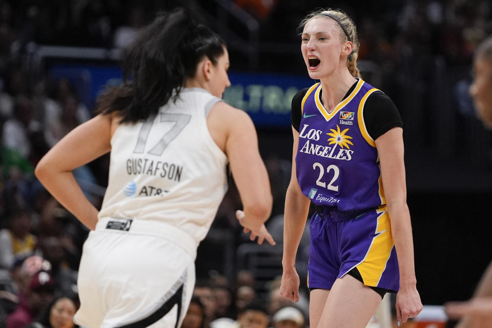 Los Angeles Sparks forward Cameron Brink (22) reacts near Las Vegas Aces center Megan Gustafson (17) after scoring a 3-point basket during the second half of a WNBA basketball game, Sunday, June 9, 2024, in Los Angeles. (AP Photo/Ryan Sun)